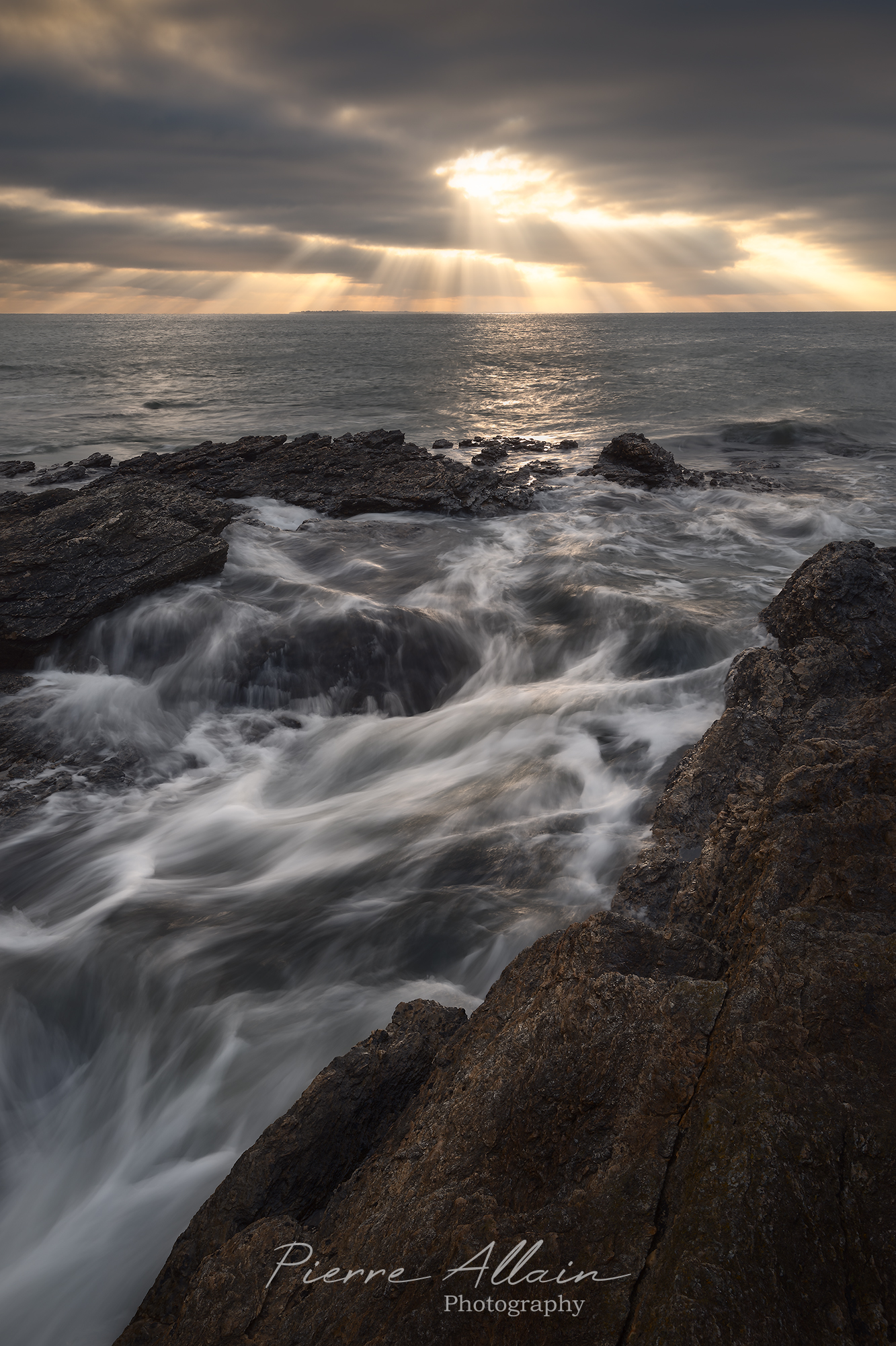 Photographie de paysage et artistique du coucher de soleil à Arzon avec lumière divine et vague fantaisie (presqu'île de rhuys, Morbihan, Bretagne, France)